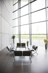 Chairs and table in office lobby area - CAIF01019