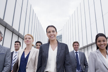 Portrait of smiling business people walking - CAIF01136