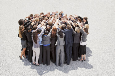 Crowd of business people in huddle - CAIF01173