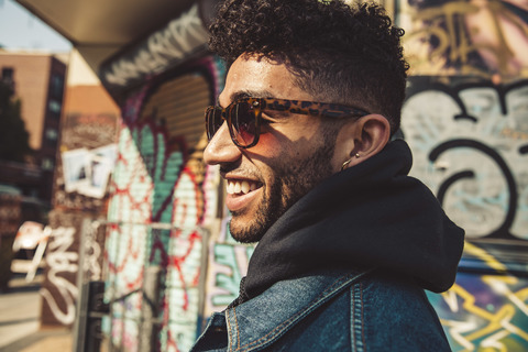 Portrait of smiling stylish young man outdoors stock photo