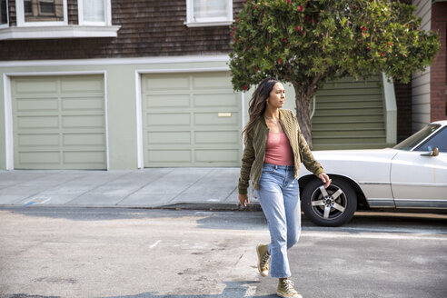 Young woman crossing the street - SUF00501