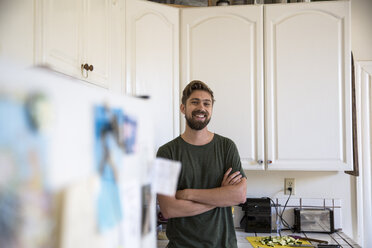 Portrait of smiling man in kitchen at home - SUF00516