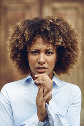 Portrait of serious woman with afro hairstyle outdoors - JSMF00030