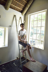Portrait of smiling young man renovating his home - ECPF00191