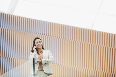 Smiling businesswoman talking on cell phone - CAIF01242