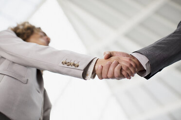 Close up of businessman and businesswoman shaking hands - CAIF01263