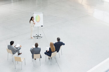 Geschäftsfrau am Flipchart leitet Sitzung in der Lobby - CAIF01266