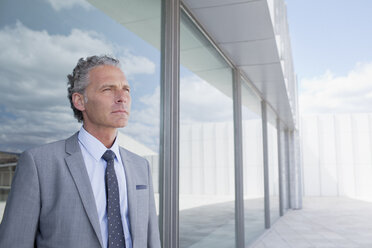 Pensive businessman outside building - CAIF01277