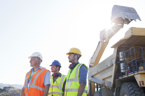 Workers standing on site stock photo