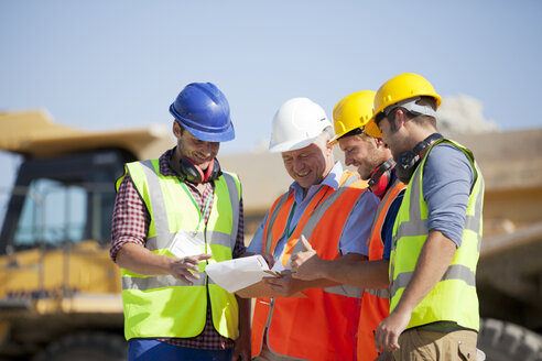 Workers and businessman talking in quarry - CAIF01414