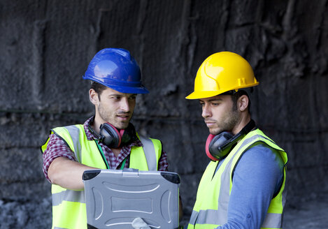 Workers using laptop in tunnel - CAIF01427