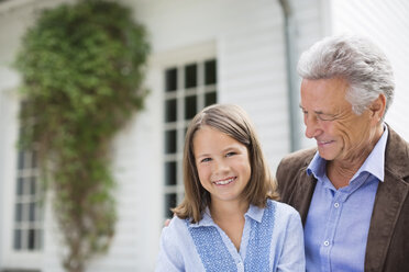 Man and granddaughter smiling outdoors - CAIF01448