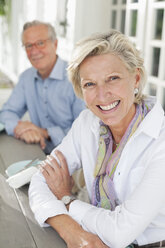 Couple smiling together at table - CAIF01474