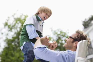 Father and son playing outdoors - CAIF01481