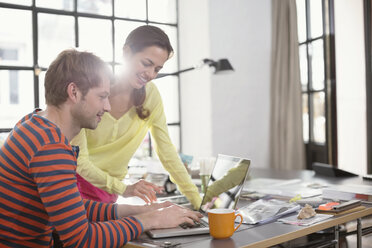 Couple working on laptop together - CAIF01551