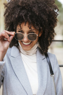 Porträt einer glücklichen Frau mit Sonnenbrille - EBSF02183
