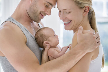 Parents cradling newborn baby - CAIF01900