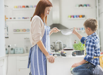 Mother and son baking in kitchen - CAIF01922