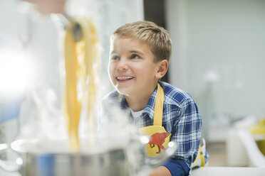 Boy smiling in kitchen - CAIF01924