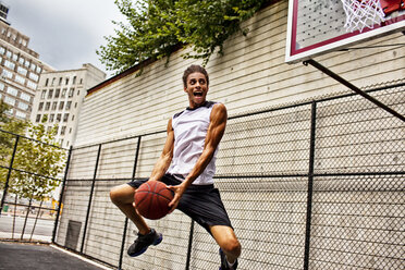 Man playing basketball on court - CAIF02099