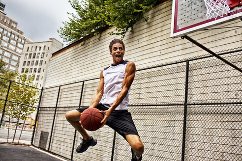 Mann spielt Basketball auf dem Platz - CAIF02099