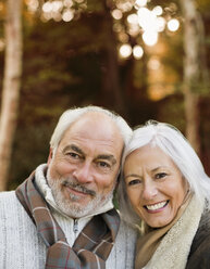 Older couple smiling together in park - CAIF02307