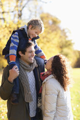 Family smiling together in park - CAIF02320