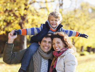 Family smiling together in park - CAIF02327