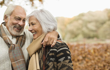 Older couple smiling together in park - CAIF02344