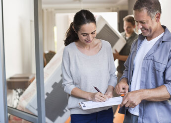 Woman signing for package - CAIF02429