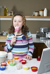 Girl licking spatula and baking - CAIF02508