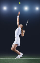 Tennis player serving ball on court - CAIF02524