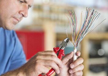 Electrician trimming wires - CAIF02539