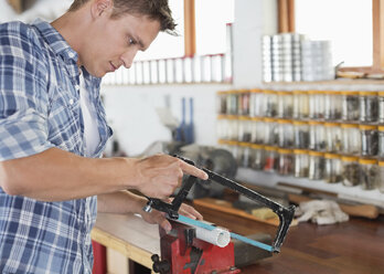 Man working in workshop - CAIF02569