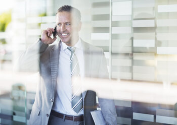 Businessman talking on cell phone - CAIF02600
