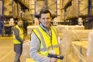 Worker scanning boxes in warehouse - CAIF02768