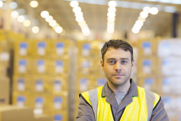 Worker standing in warehouse - CAIF02770