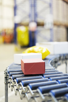Packages on conveyor belt in warehouse - CAIF02828
