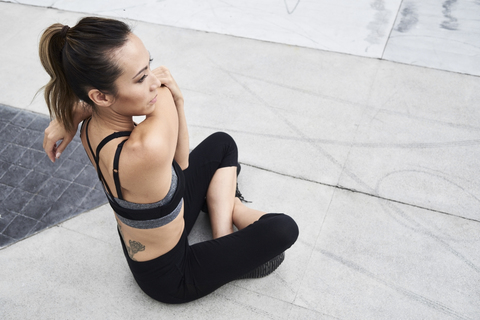 Fit woman stretching outdoors stock photo
