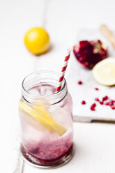 Fruit infused water with lemon slices, crushed pomegranate seeds and sparkling water - SBDF03473