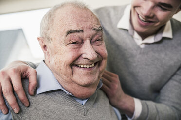 Portrait of happy senior man with young man - UUF12871