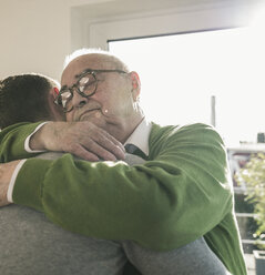 Senior man hugging young man - UUF12891