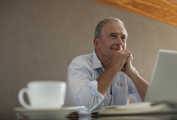 Businessman sitting at desk - CAIF02950