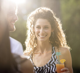 Couple having drinks outdoors - CAIF03039