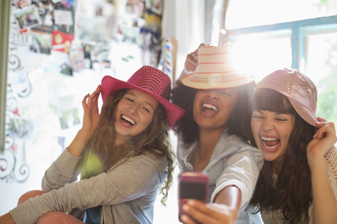 Women wearing hats in bedroom stock photo