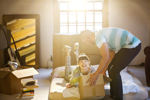 Couple unpacking boxes in attic stock photo