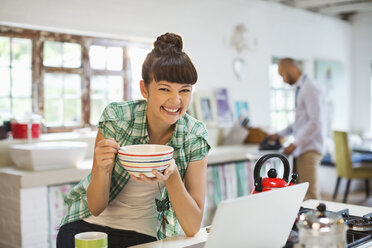 Woman using laptop at breakfast - CAIF03168