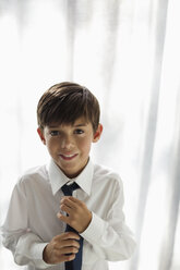 Smiling boy wearing shirt and tie - CAIF03218