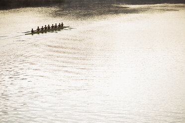 Rowing team in scull on sunny lake - CAIF03231