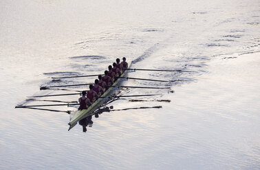 Rowing team rowing scull on lake - CAIF03247